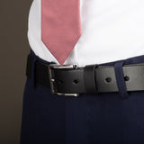 Oxford strap - formal leather belt for men in black with silver buckle on model in suit from side