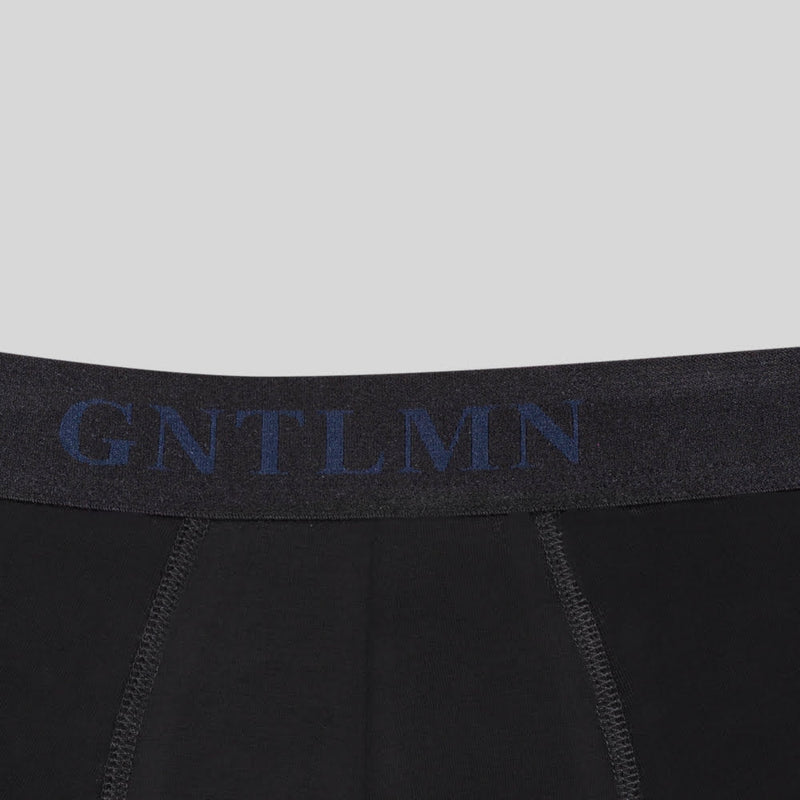 closeup of waistband of black boxer briefs - gntlmn in navy writing